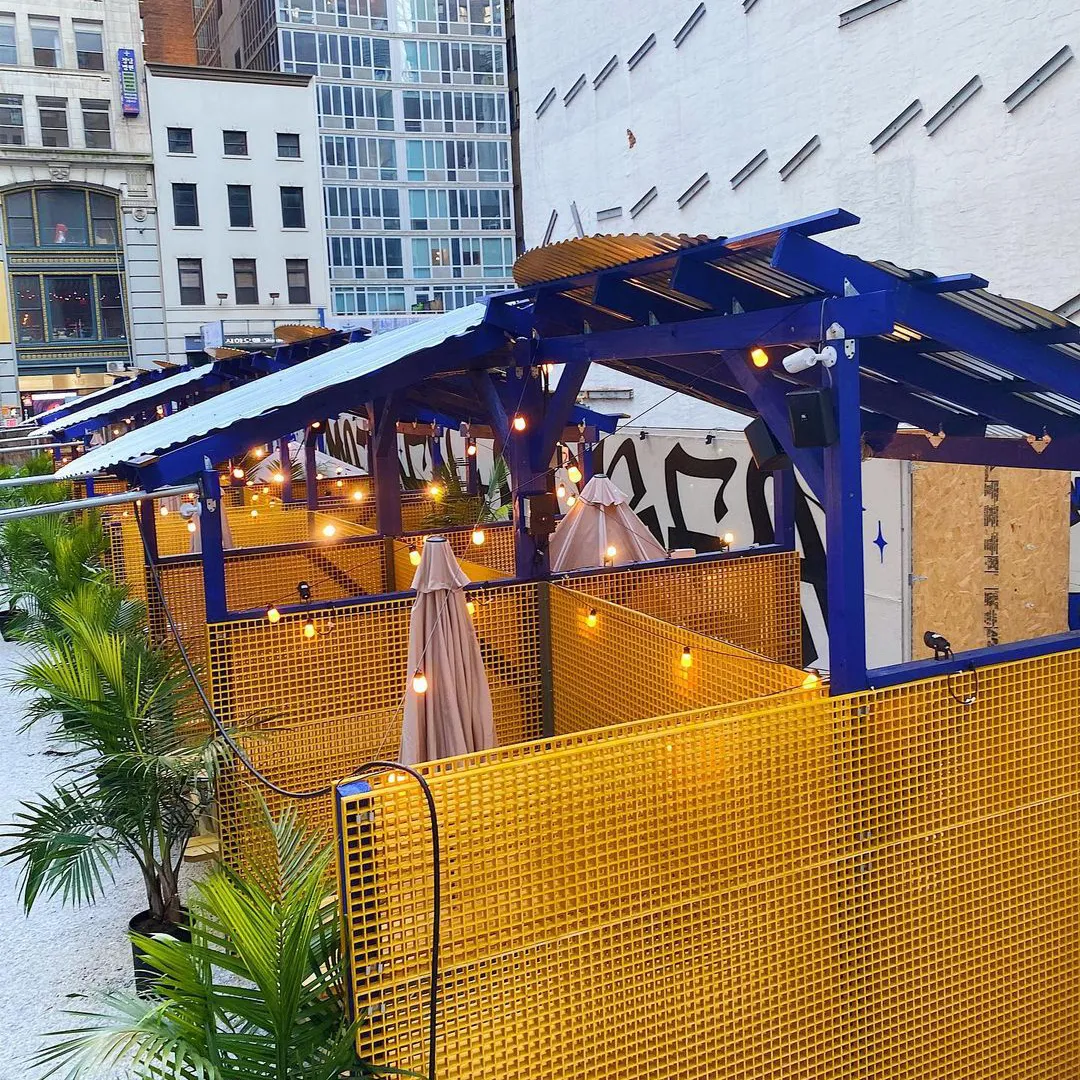 Palms and cobalt pavilions inside the lot